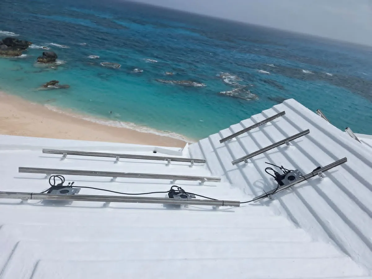 Solar racking left on a Bermuda roof with the panels removed, the sea behind