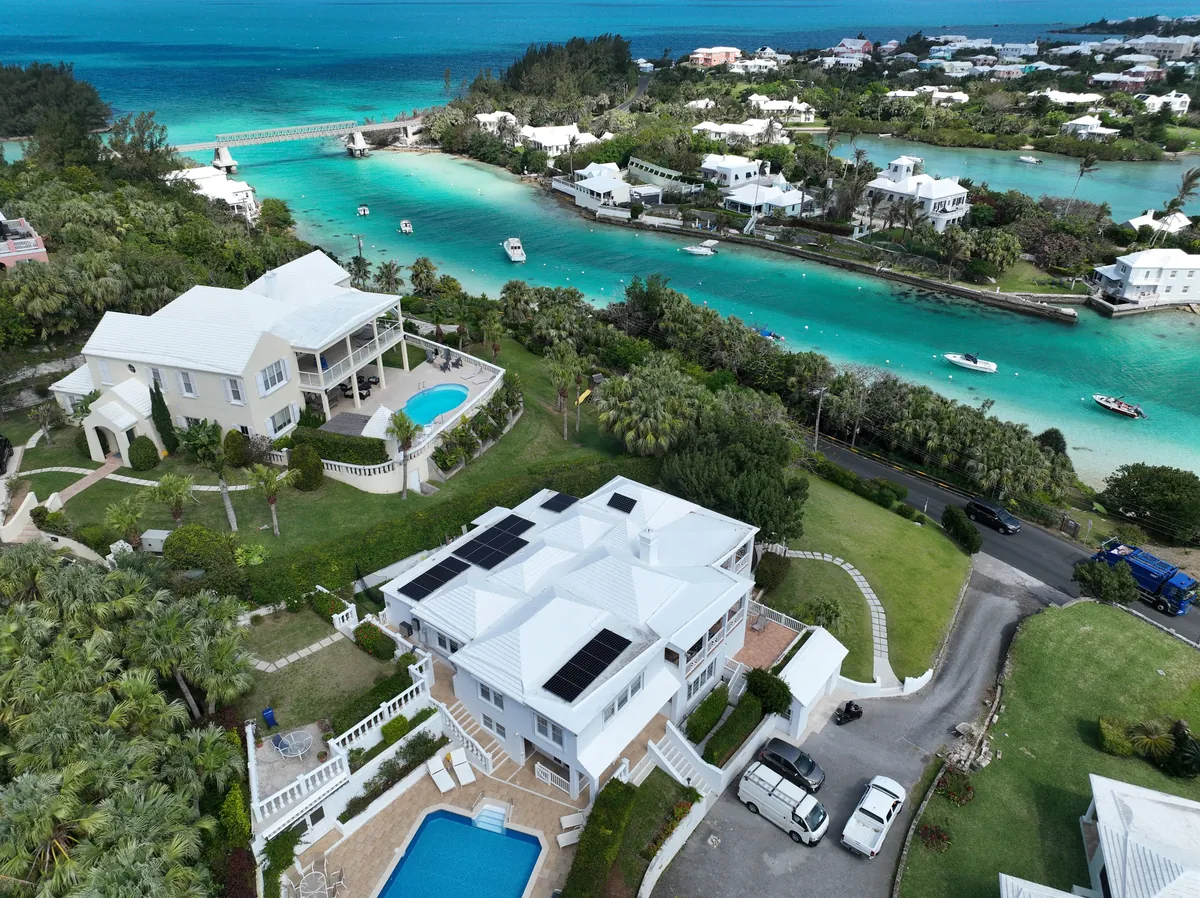 A private residence in Bermuda with Maxeon solar panels on a white roof, seen from the air
