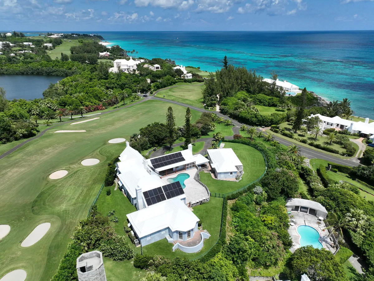 A private residence in Bermuda with Maxeon solar panels on a white roof, seen from the air