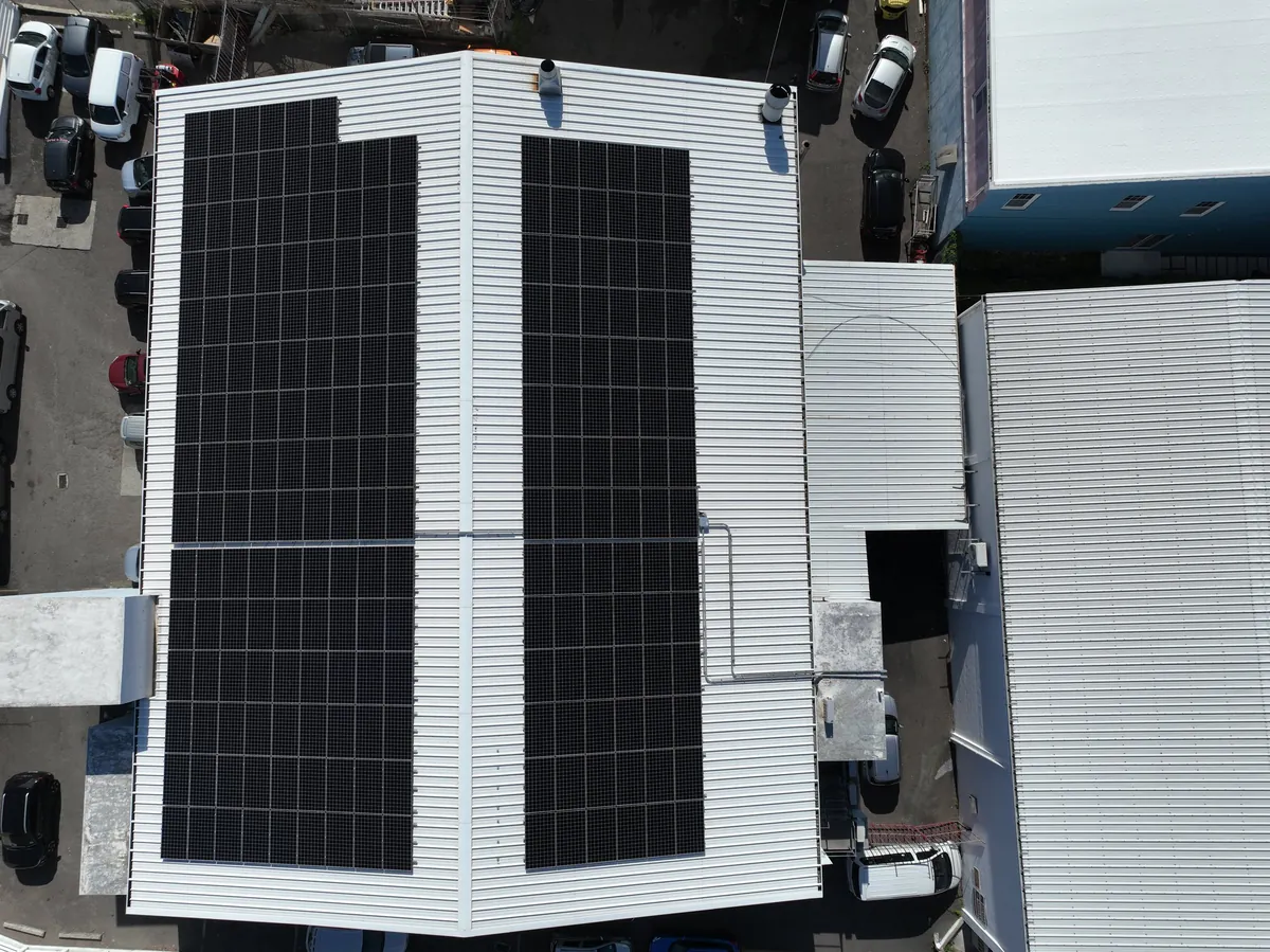 Solar panels covering both slopes of the Rayclan building roof in Pembroke, Bermuda, seen from directly above